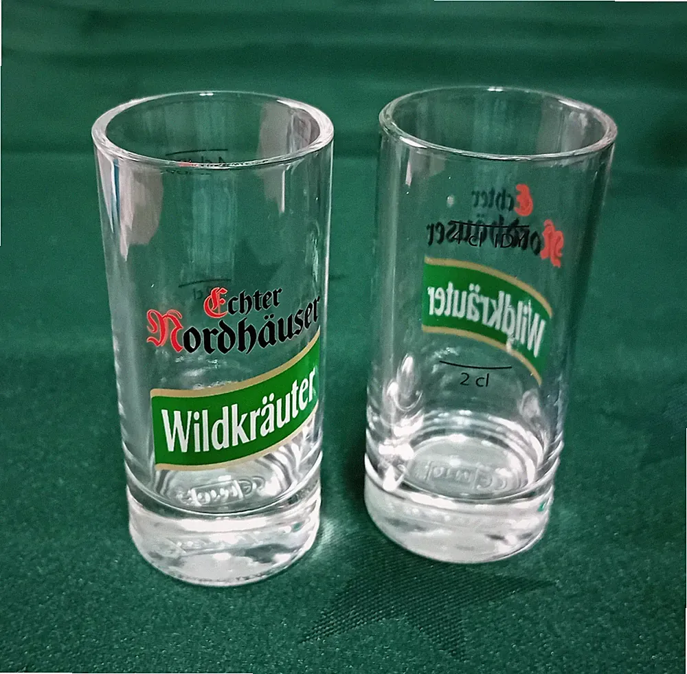 2 Schnapsgläser, Echter Nordhäuser Wildkräut, Feier-Erinn.-glas, mit Firmenlogo